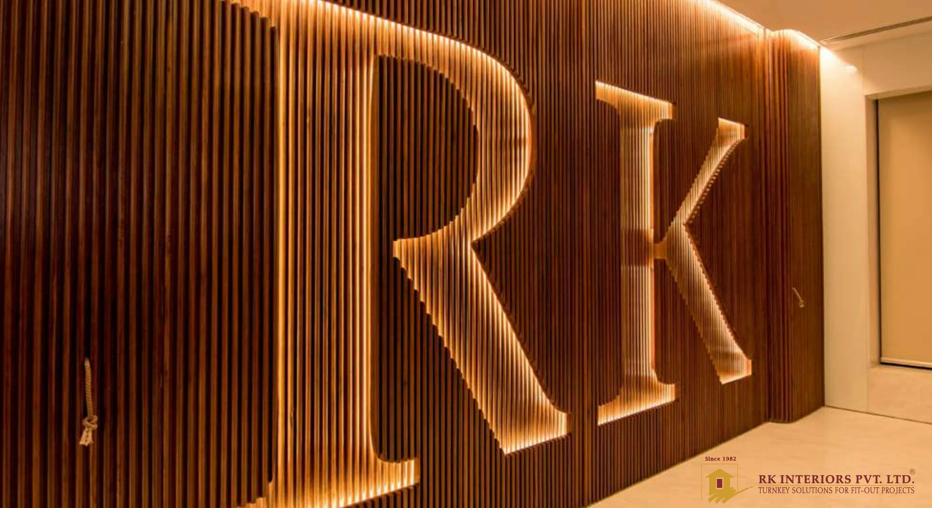 Backlit RK signage on fluted timber battens in a completed reception